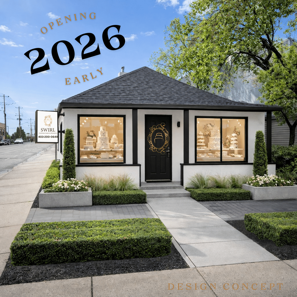 luxury white stucco building with black trim and stunning tiered wedding cakes in the window